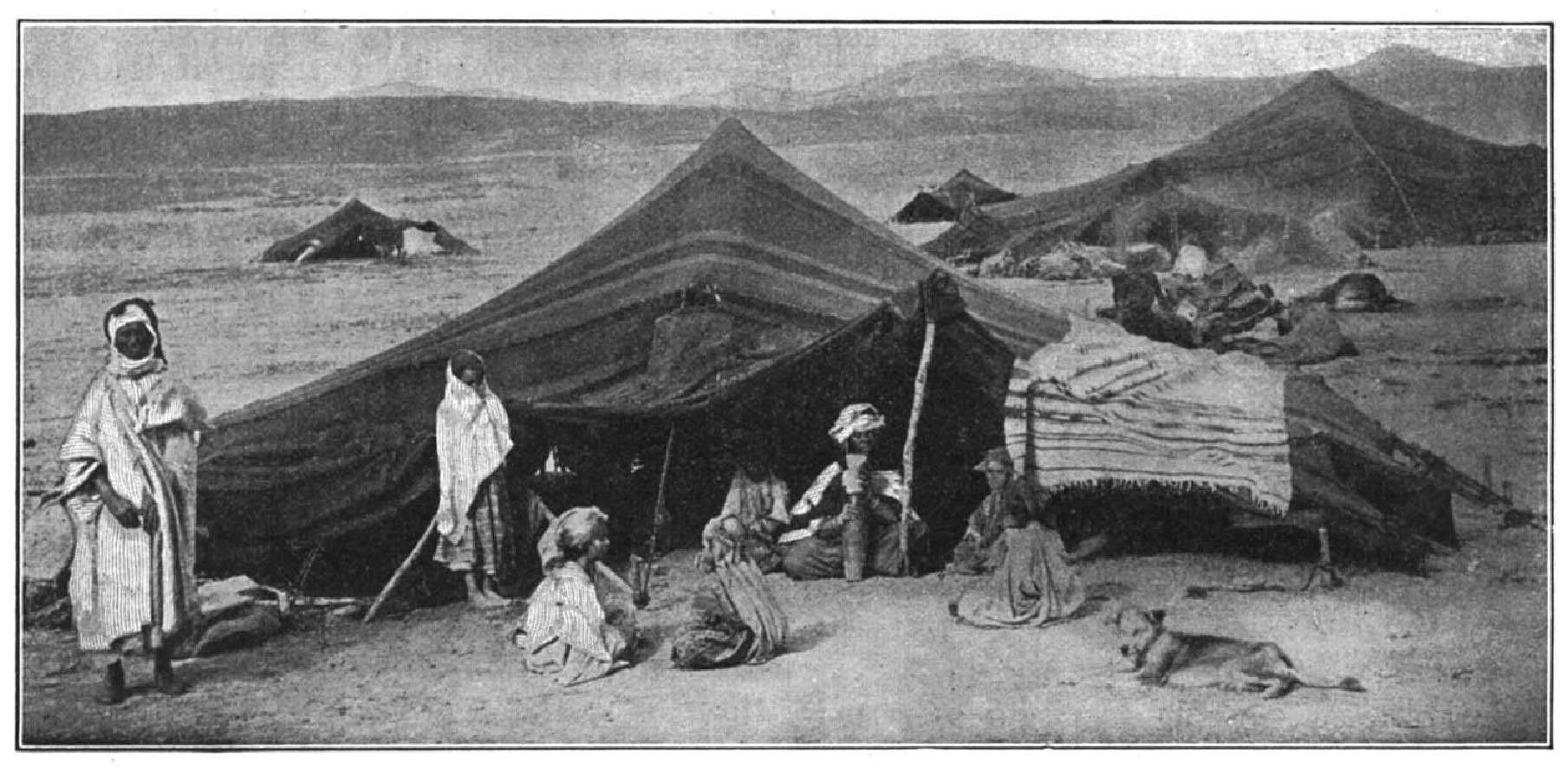 Title: World's Geographies (1919)?Author: Tarr and McMurry?Illustrator: NA?Publisher: McMillan Co.?Copyright (c) 1996 Zedcor Inc. All Rights Reserved.?Keywords: Nomads Algeria desert Biskra Africa woman children tents, b/w??